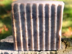 bar of goat milk soap with peppermint essential oils, coffee and oatmeal