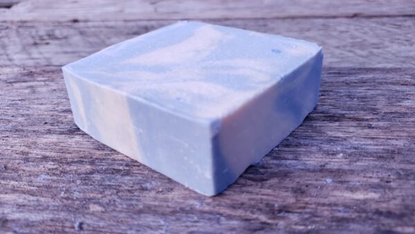 honeysuckle mint goat milk soap bar on wood