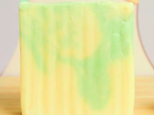 gardenia goat milk soap bar against pastel polka dot background