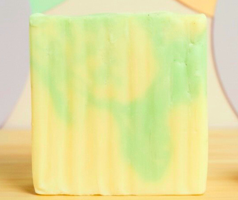 gardenia goat milk soap bar against pastel polka dot background